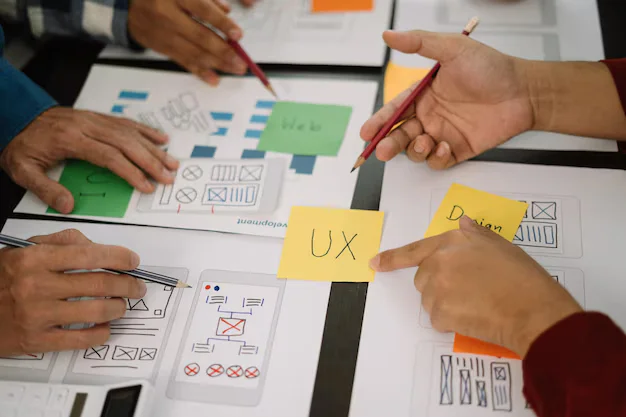 Wireframes and design notes on a desk
