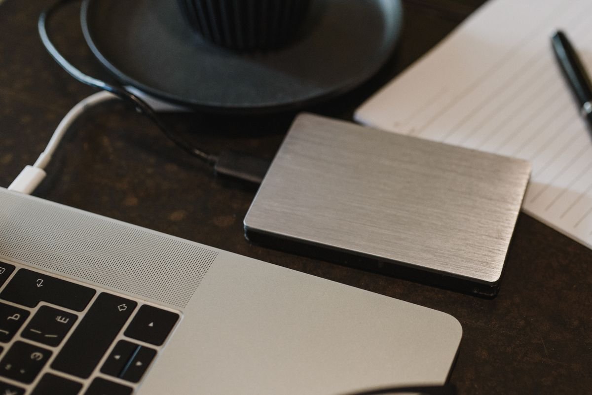 External hard drive connected to a laptop by USB cable