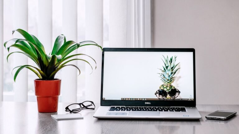 Laptop with a document open beside a notebook