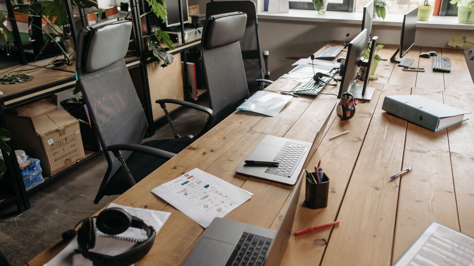 Laptop on a desk with files open