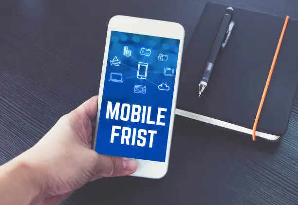 Phone and laptop showing the same website