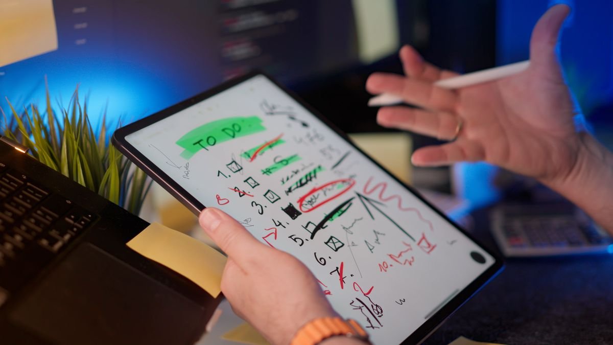 Person managing tasks on a tablet with a digital pen