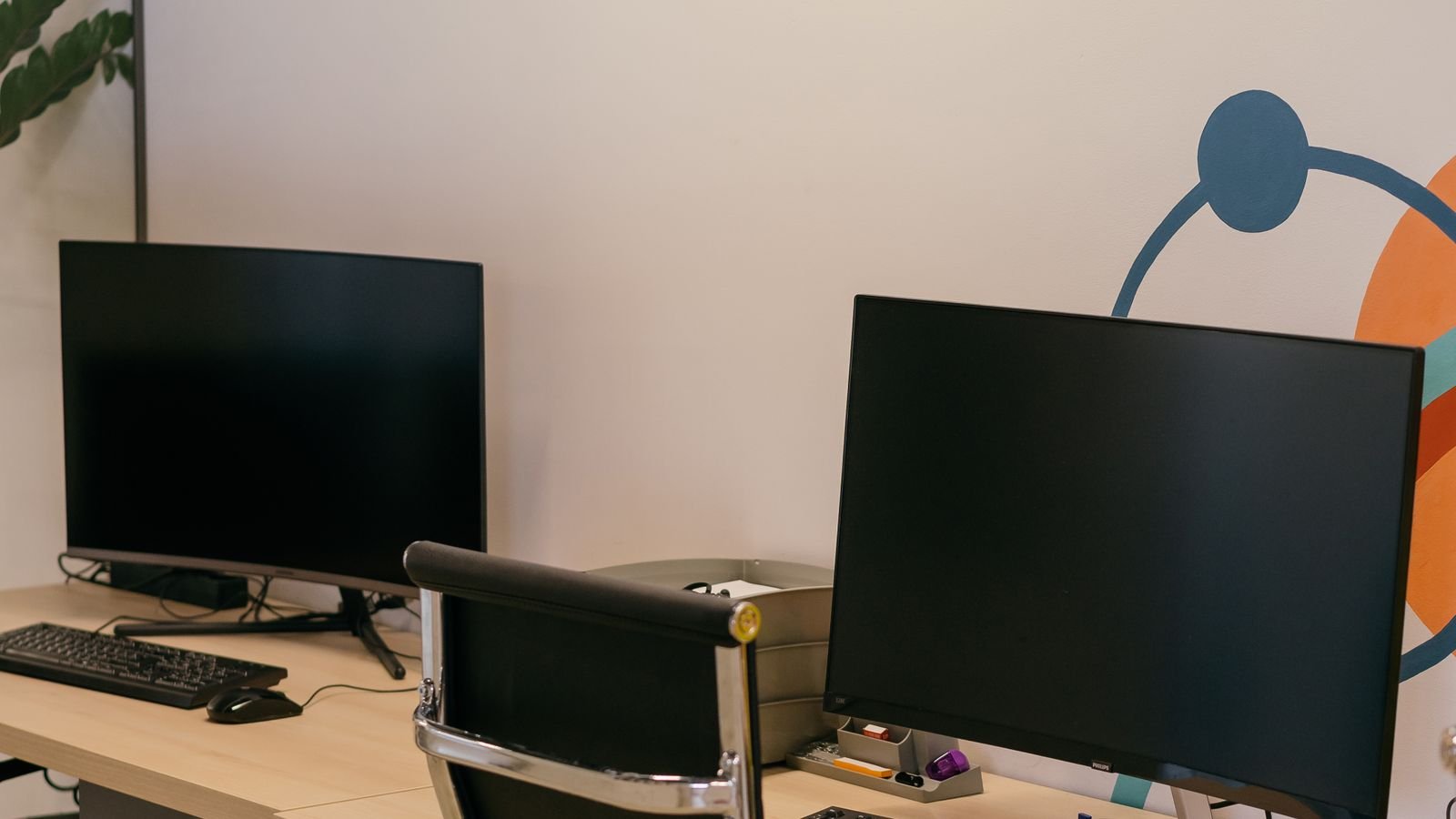 Laptop and monitor on a desk showing the same workspace on two screens