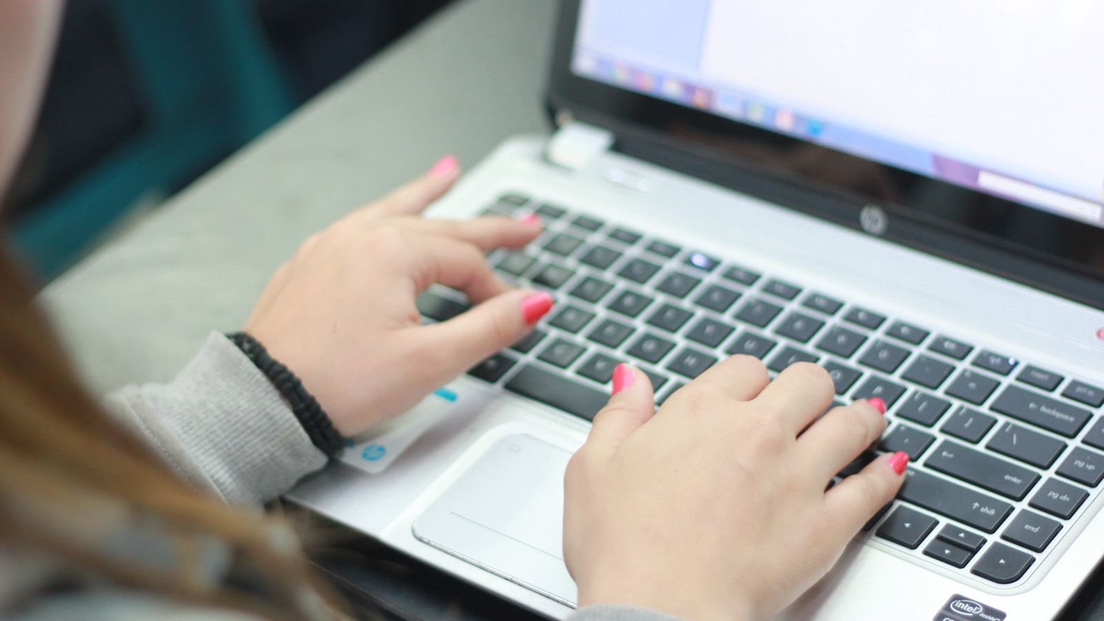 Person working on a laptop at a desk