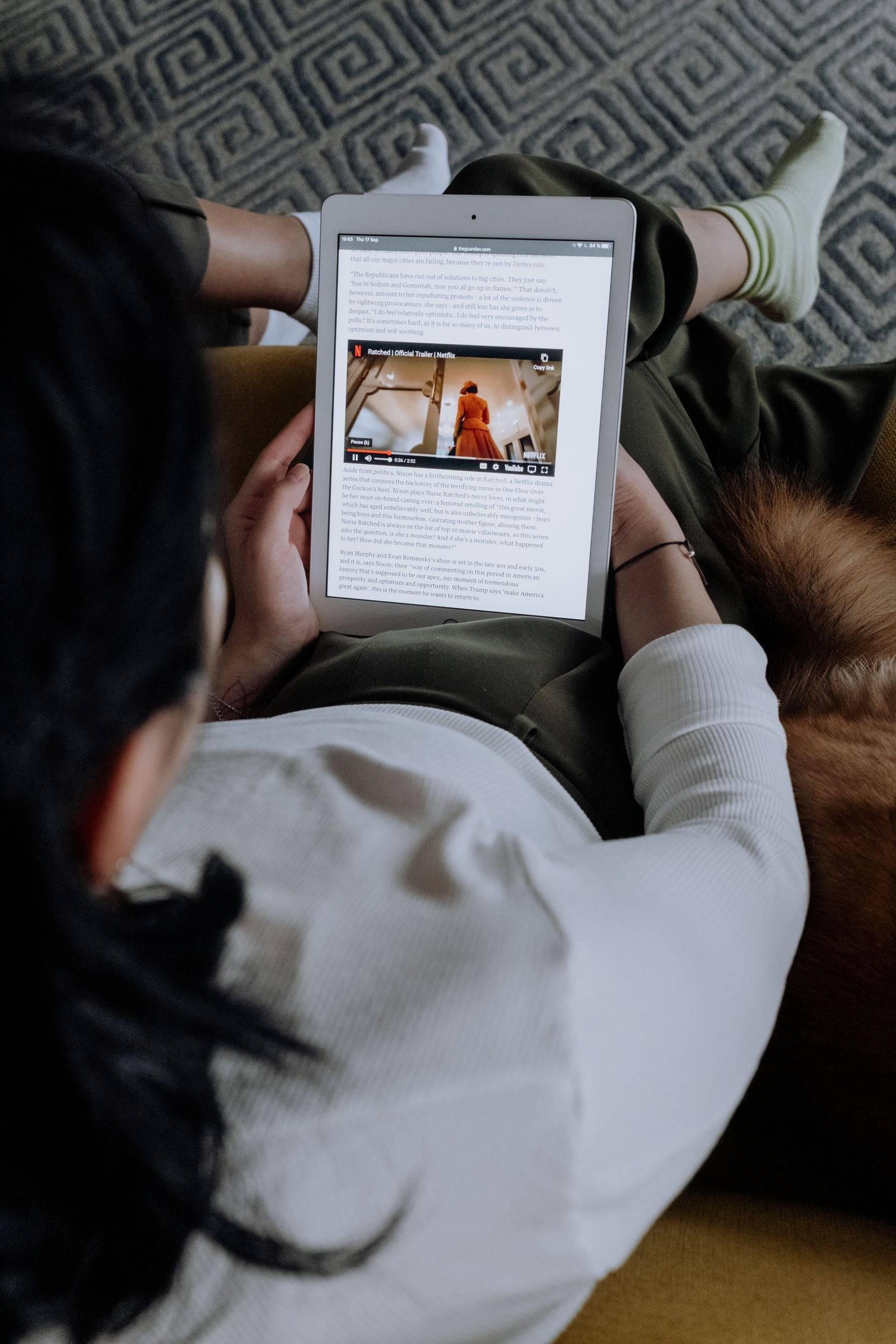 Person reading an article on a tablet