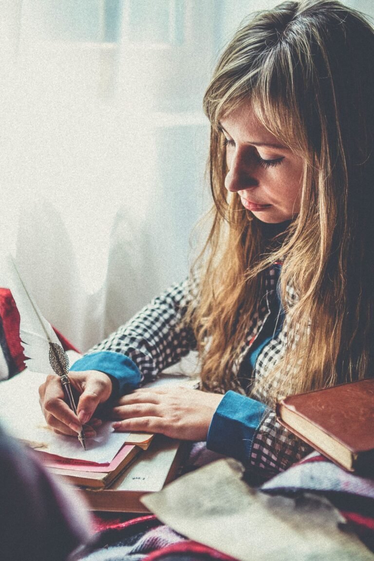 Person writing at a laptop