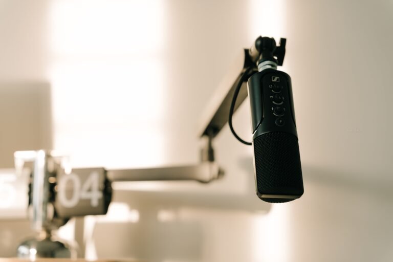 A professional microphone on a boom arm in a recording studio