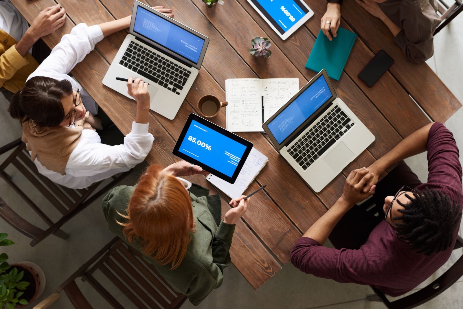 Team collaborating around a laptop