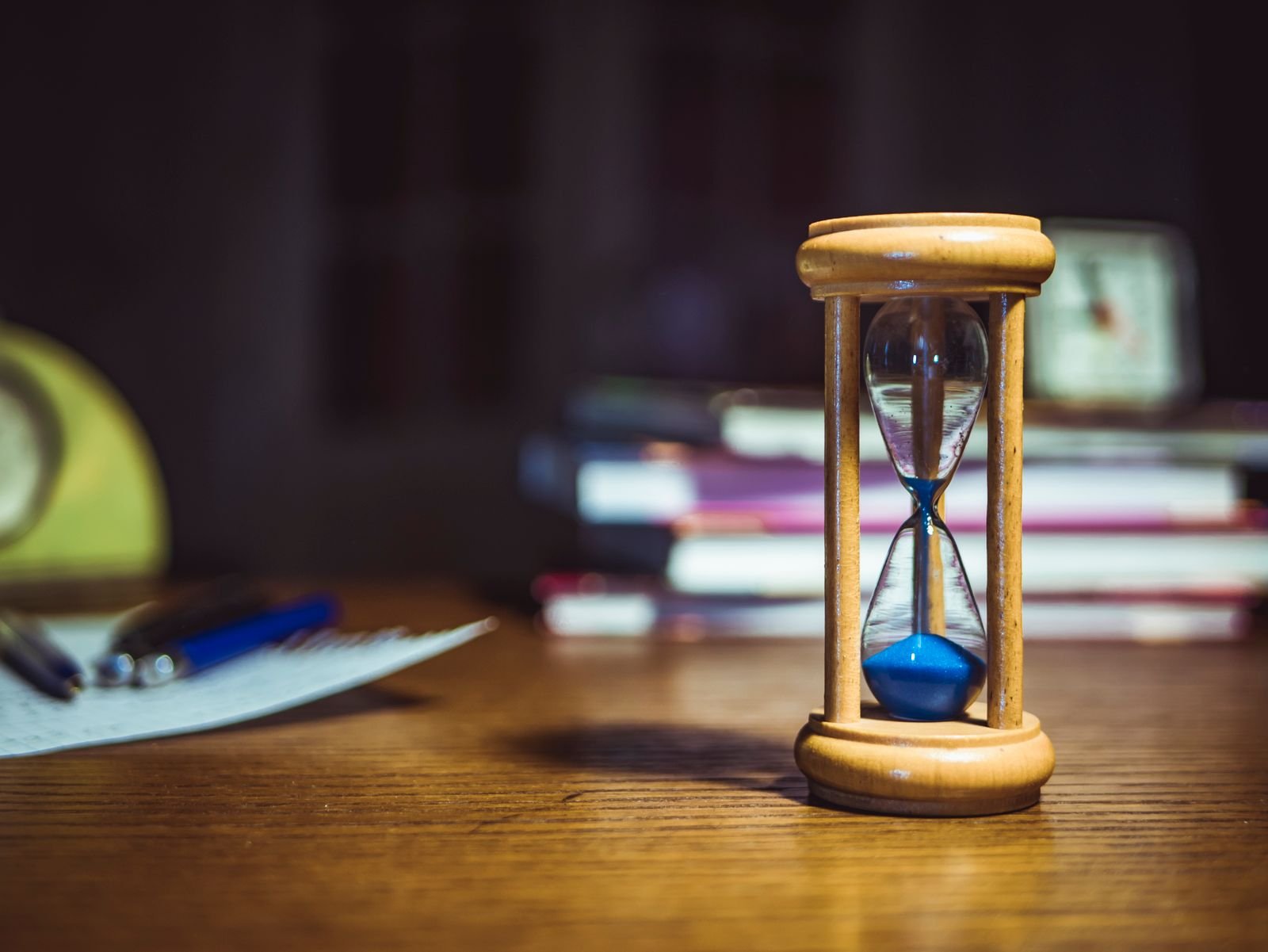 Wristwatch and notebook beside a laptop