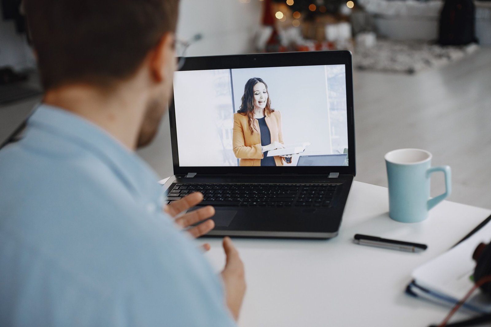 A laptop screen showing a video call with several participants